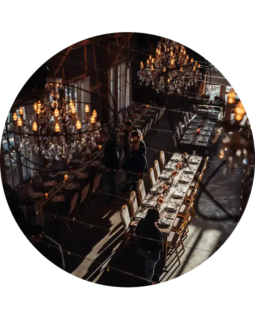 Eleganter Restaurantraum mit Kronleuchtern und festlich gedeckten Tischen.